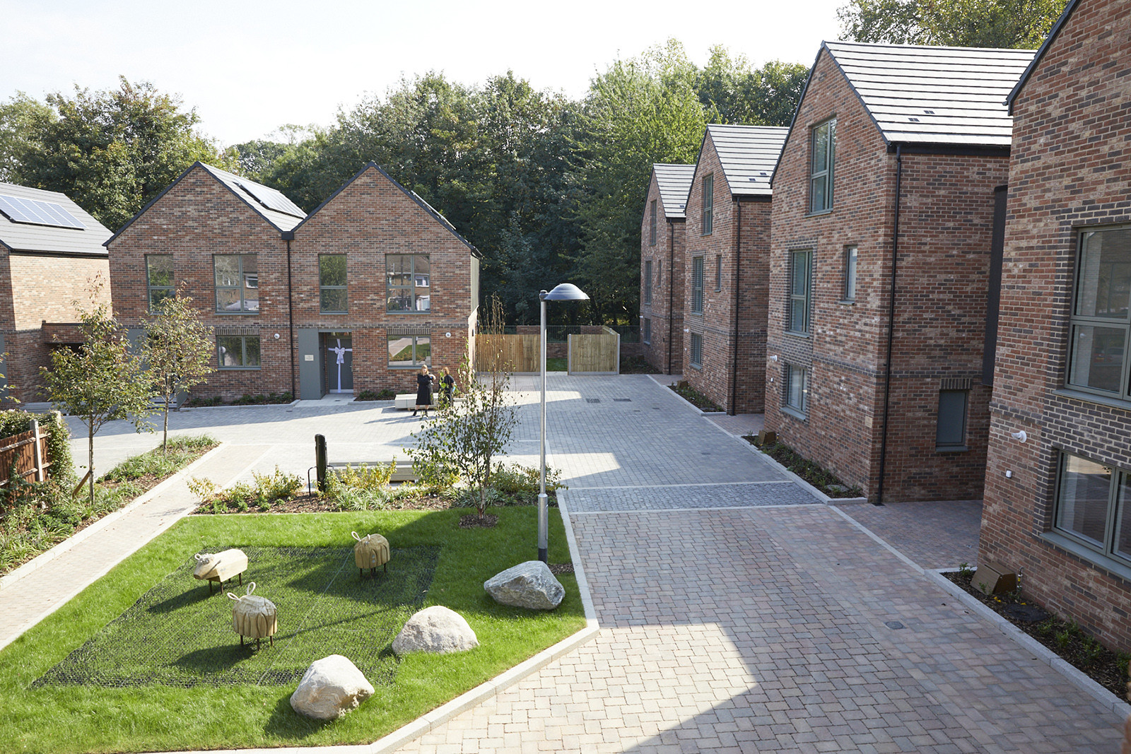 New brick homes and a paved courtyard on the Ravensbury estate